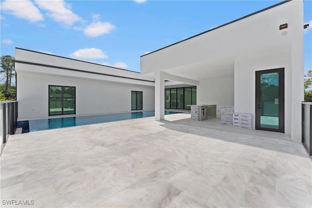 back of house with a patio