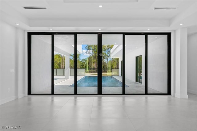 doorway to outside with floor to ceiling windows