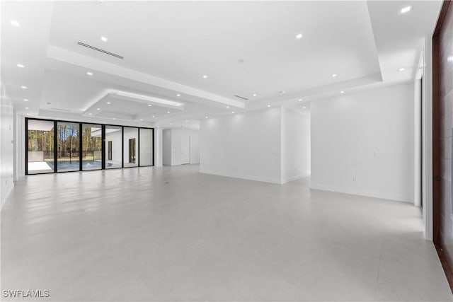 unfurnished room with a raised ceiling