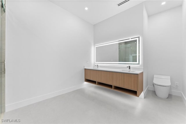bathroom with vanity, walk in shower, and toilet
