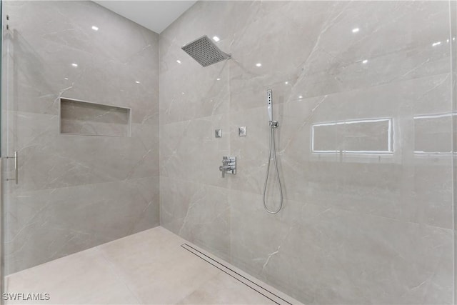 bathroom with tiled shower