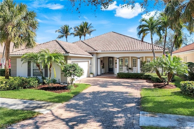 mediterranean / spanish home with a garage