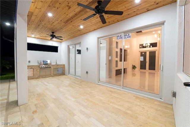 view of patio / terrace featuring ceiling fan and an outdoor kitchen