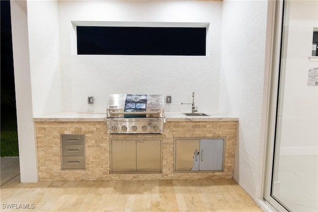 bar featuring sink and light hardwood / wood-style floors