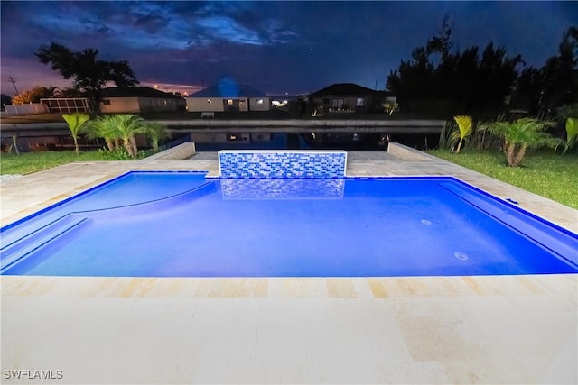 view of pool at dusk