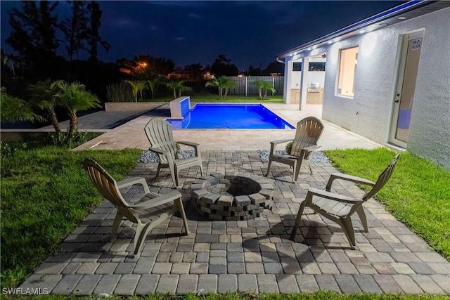 view of swimming pool with a patio area and an outdoor fire pit