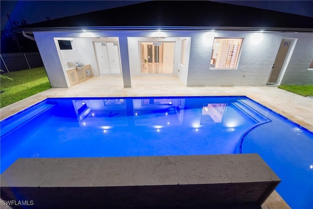 view of pool featuring a patio and an outdoor kitchen