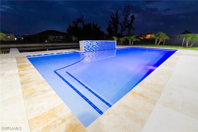 view of pool at night