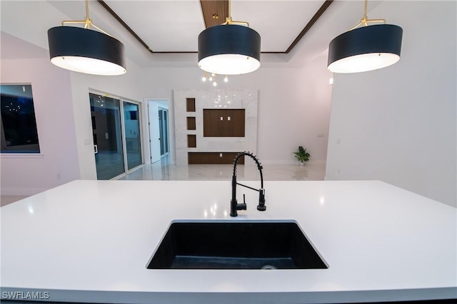 kitchen featuring decorative light fixtures and sink