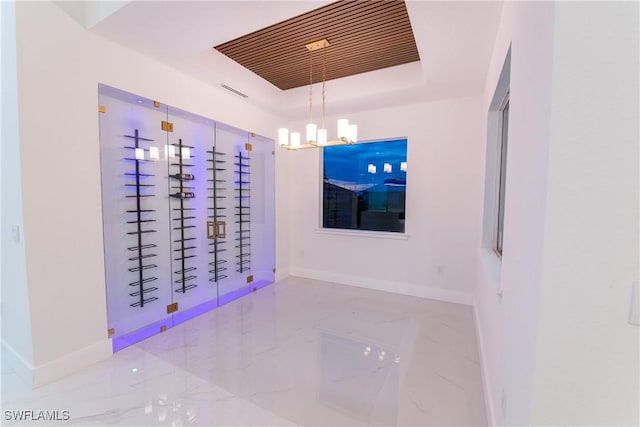 interior space featuring a chandelier and a tray ceiling