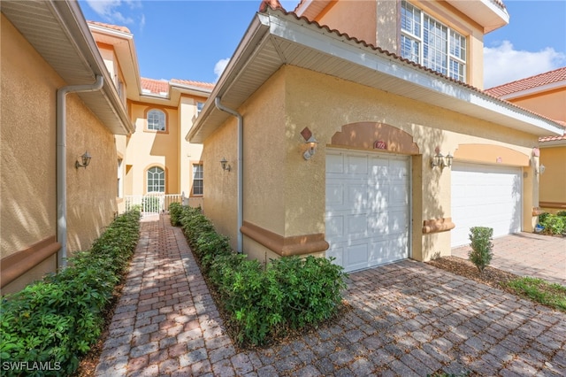 view of exterior entry with a garage