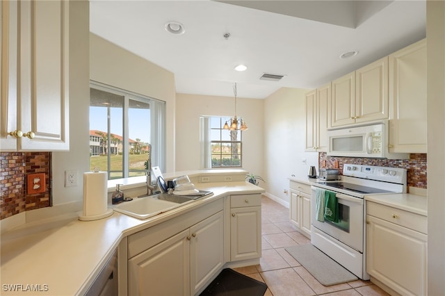 kitchen featuring sink, tasteful backsplash, hanging light fixtures, light tile patterned floors, and white appliances