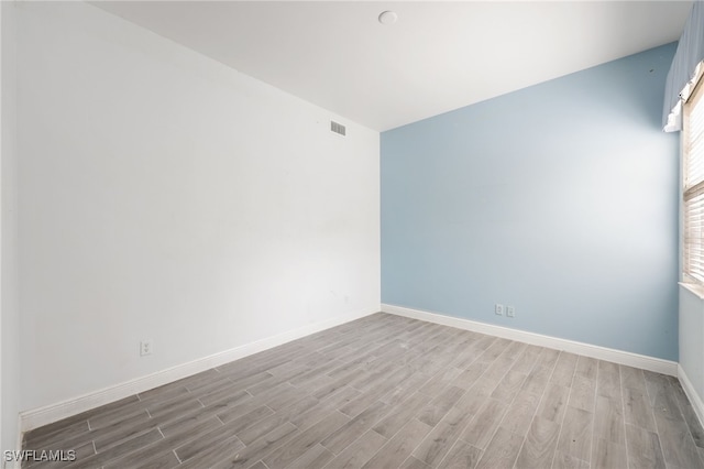 unfurnished room featuring wood-type flooring