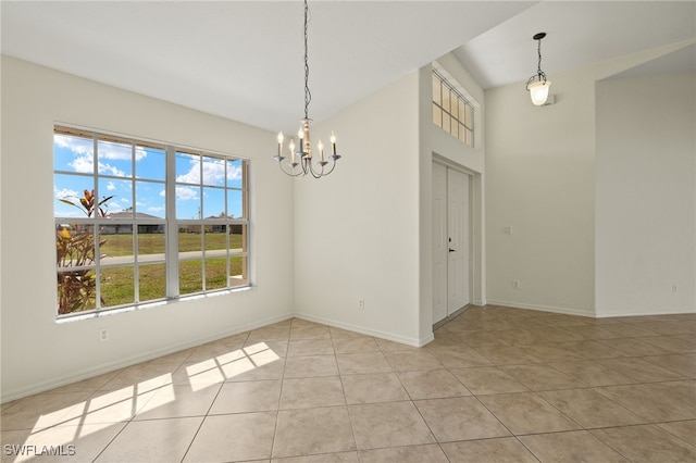 unfurnished dining area with a notable chandelier and light tile patterned floors