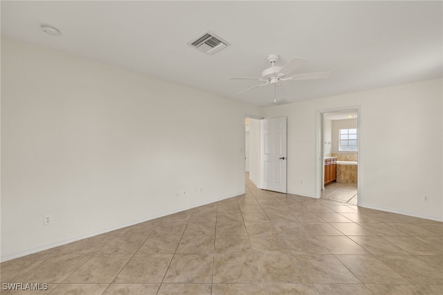 empty room featuring light tile patterned floors and ceiling fan