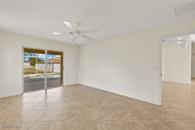 empty room with light tile patterned floors and ceiling fan