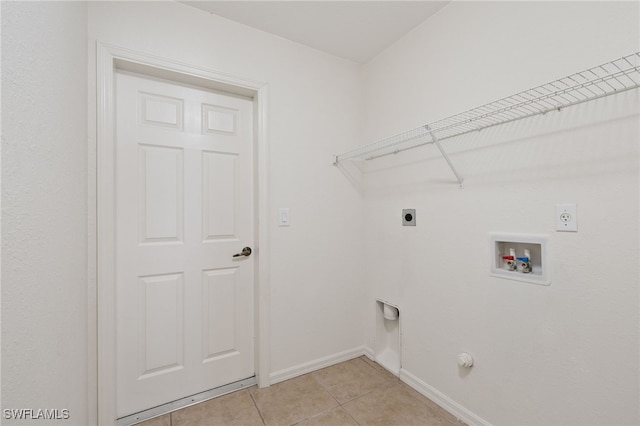 laundry area featuring electric dryer hookup, washer hookup, light tile patterned floors, and gas dryer hookup