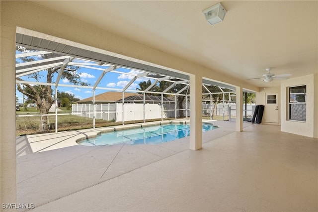 view of swimming pool featuring a lanai, a patio area, and ceiling fan