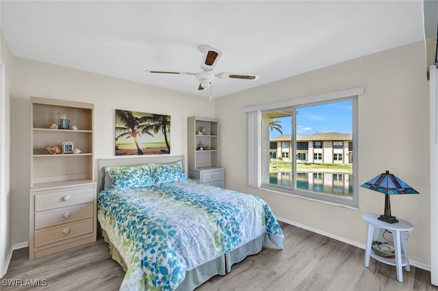 bedroom with ceiling fan and light hardwood / wood-style floors