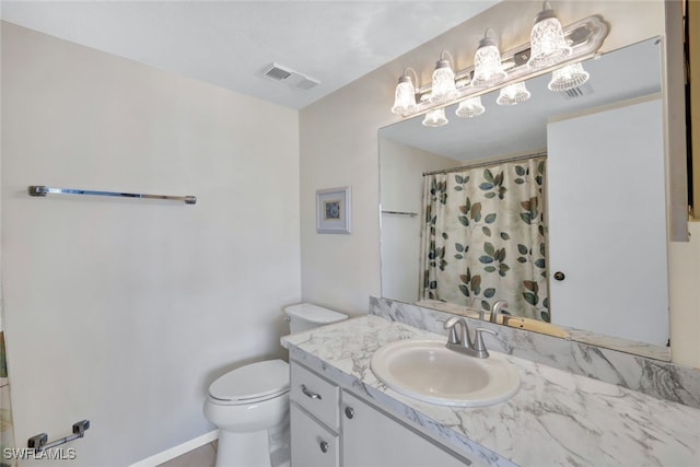 bathroom featuring vanity, toilet, and walk in shower