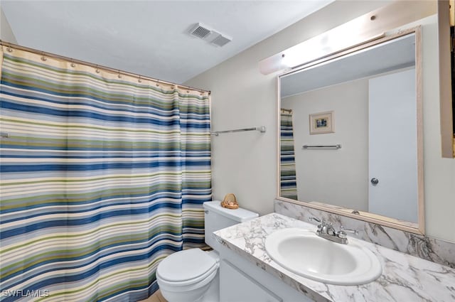 bathroom featuring toilet, curtained shower, visible vents, and vanity