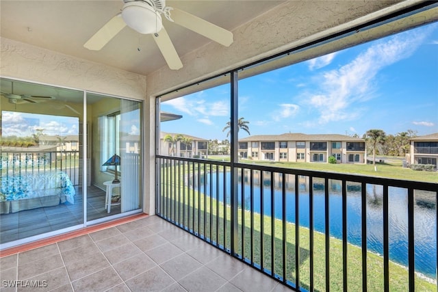 unfurnished sunroom with a water view and ceiling fan