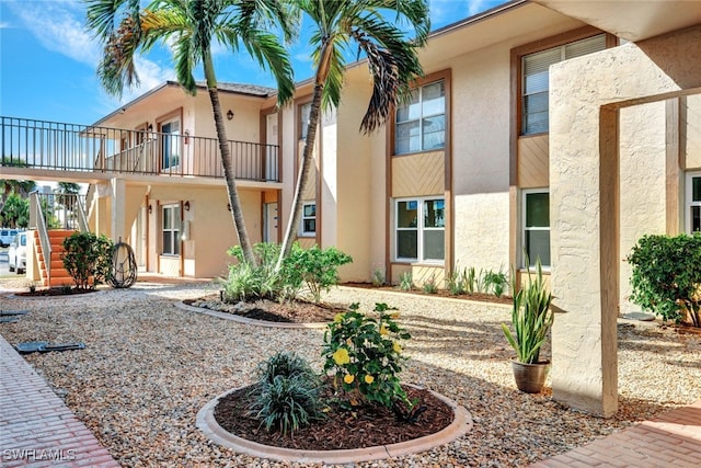 back of property featuring a balcony