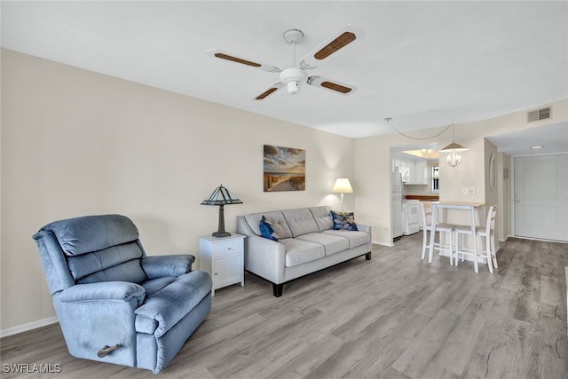 living room featuring light hardwood / wood-style floors and ceiling fan