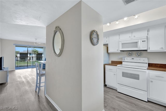 kitchen featuring ceiling fan, white appliances, light wood-type flooring, and white cabinets