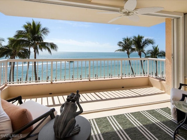 balcony with a water view and ceiling fan