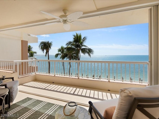 balcony featuring a water view and ceiling fan