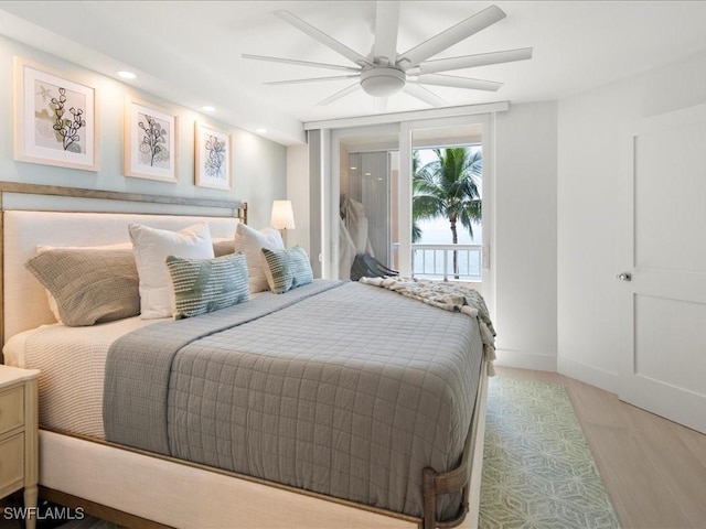 bedroom with access to outside, ceiling fan, and light wood-type flooring