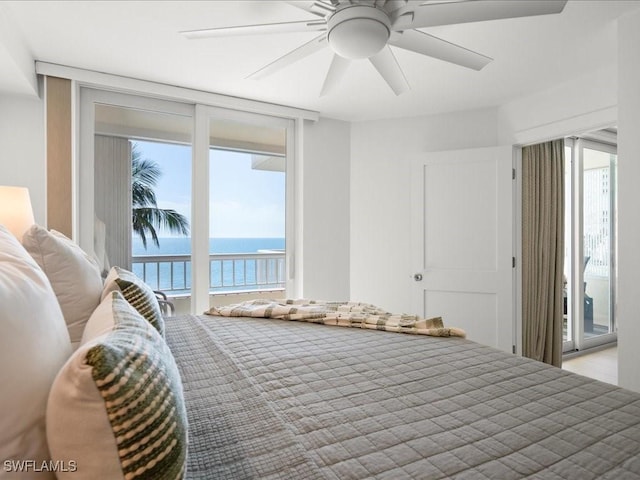 bedroom featuring a water view, ceiling fan, and access to outside