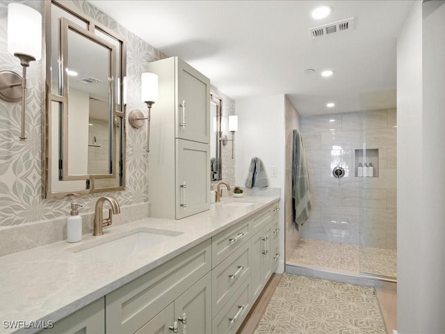 bathroom with vanity and tiled shower