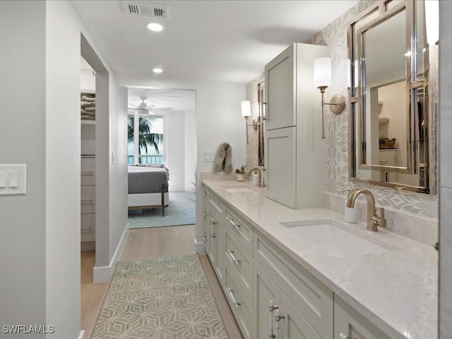 bathroom with vanity, hardwood / wood-style floors, and ceiling fan