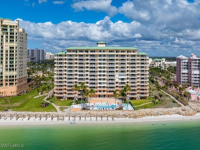 view of property with a water view and a view of the beach