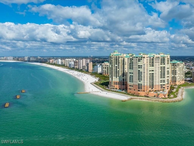 birds eye view of property with a water view and a view of the beach