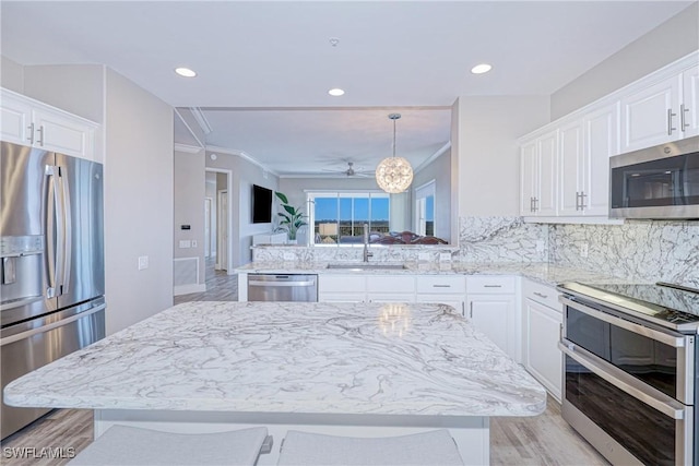 kitchen featuring white cabinetry, stainless steel appliances, and kitchen peninsula