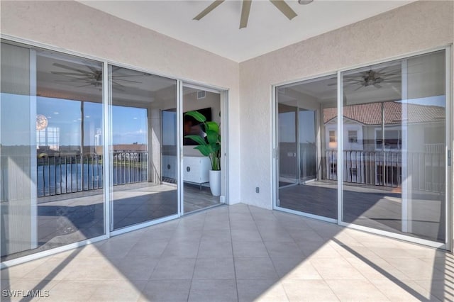 unfurnished sunroom with ceiling fan