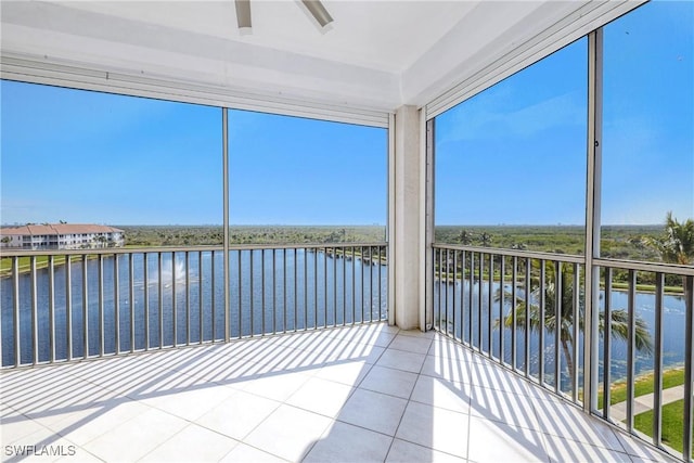 unfurnished sunroom featuring a water view