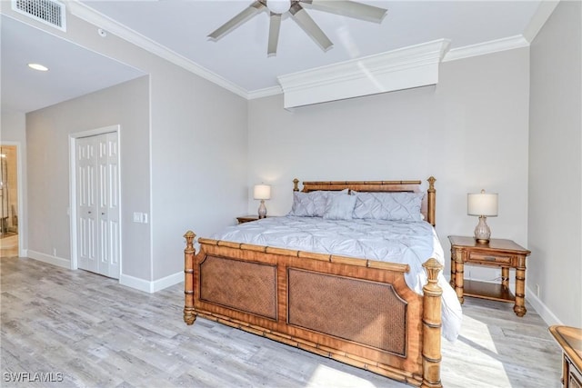 bedroom with ceiling fan, ornamental molding, a closet, and light wood-type flooring