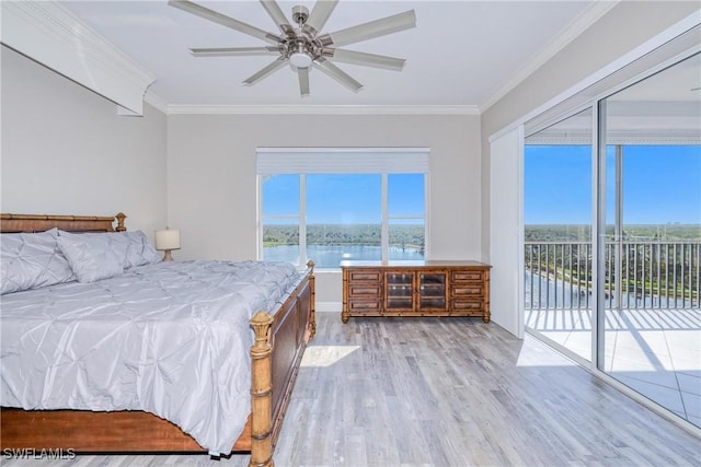 bedroom featuring ornamental molding, a water view, access to outside, and light hardwood / wood-style flooring