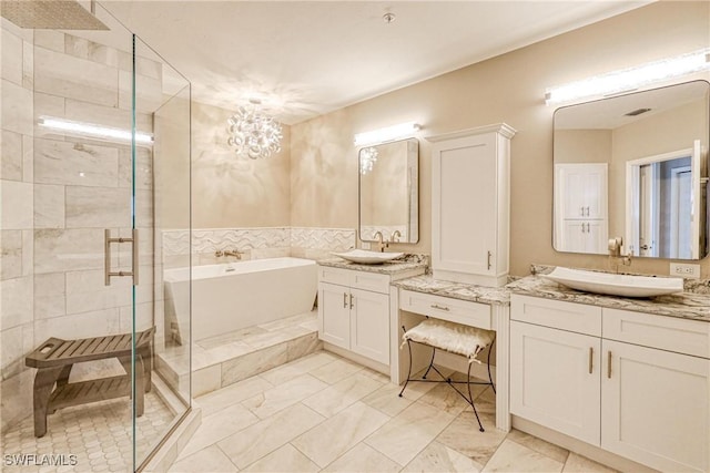 bathroom featuring vanity and shower with separate bathtub