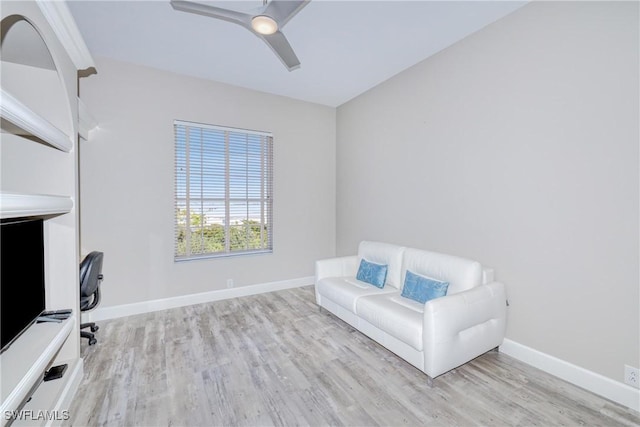 living area with ceiling fan and light hardwood / wood-style flooring