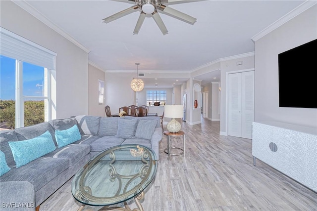 living room featuring crown molding, ceiling fan, and light hardwood / wood-style floors