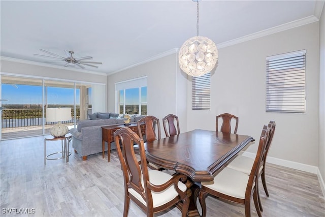 dining room with crown molding, ceiling fan with notable chandelier, and light hardwood / wood-style floors