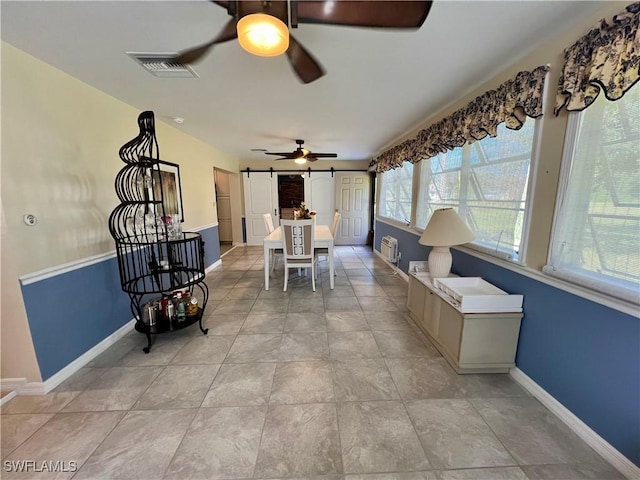 sunroom featuring ceiling fan