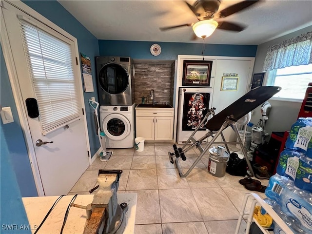 washroom featuring stacked washing maching and dryer, light tile patterned flooring, sink, cabinets, and ceiling fan