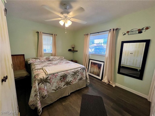 bedroom with dark wood-type flooring and ceiling fan