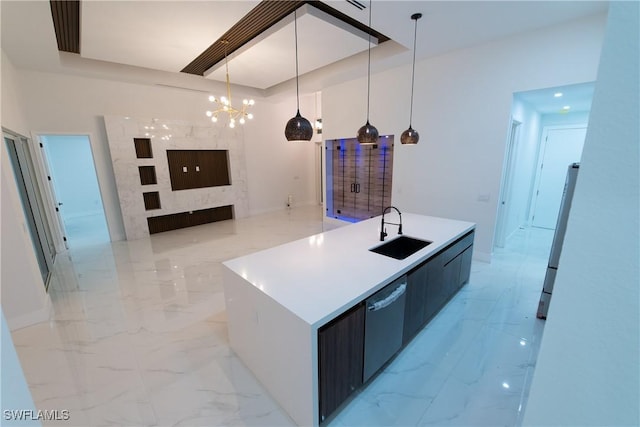 kitchen with pendant lighting, sink, dishwasher, refrigerator, and a kitchen island with sink